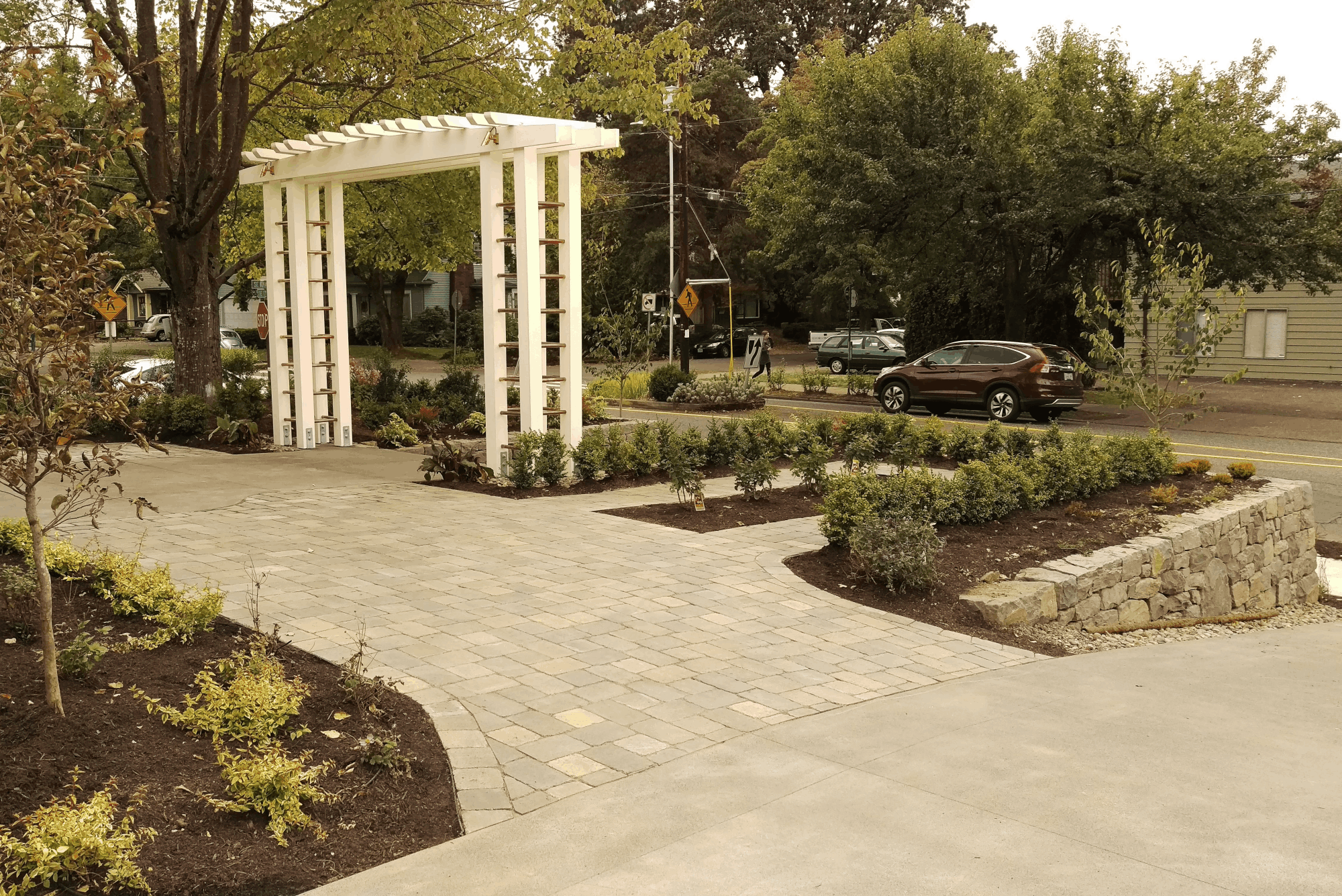 This hardscape leading up to a classic outdoor structure brings a touch of class.