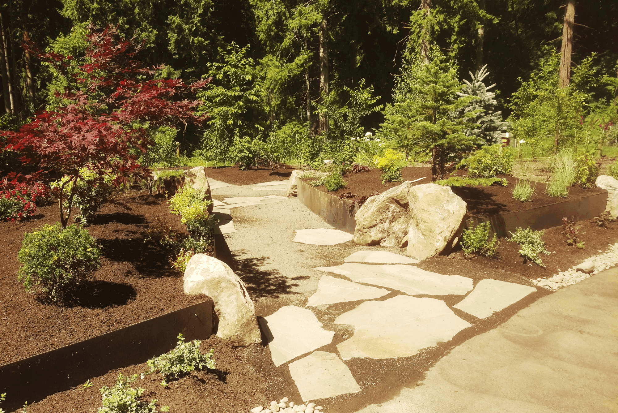 A warming fire structure extends the outdoor enjoyment of this beautiful hardscape.