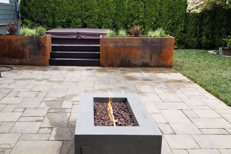 The element of fire combines with retaining walls and patio to create a touch of warmth.