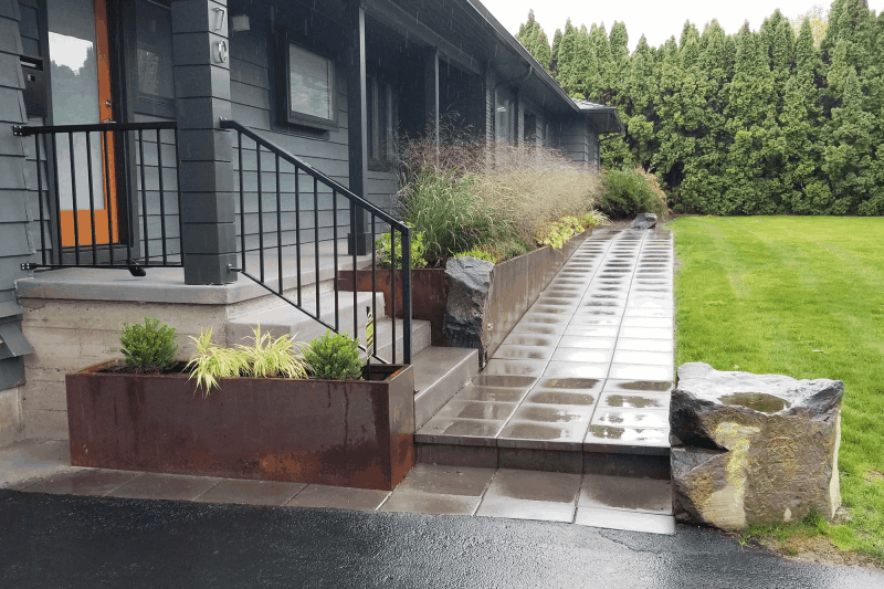 These steps and walkway add appeal to this home's entrance.